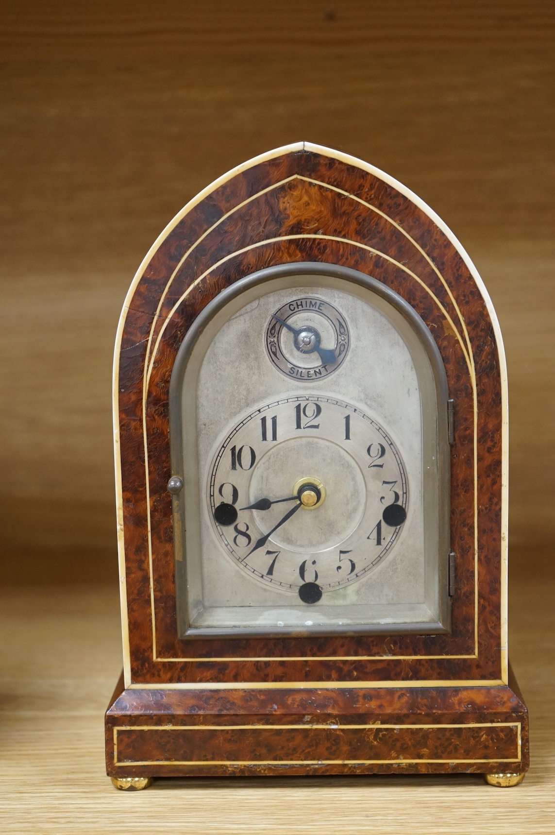An early 20th century French eight day Amboyna mantel clock, with Holly and ivory stringing, retailed by Charles Frodsham, 25cm high CITES Submission reference 3SPE5K23